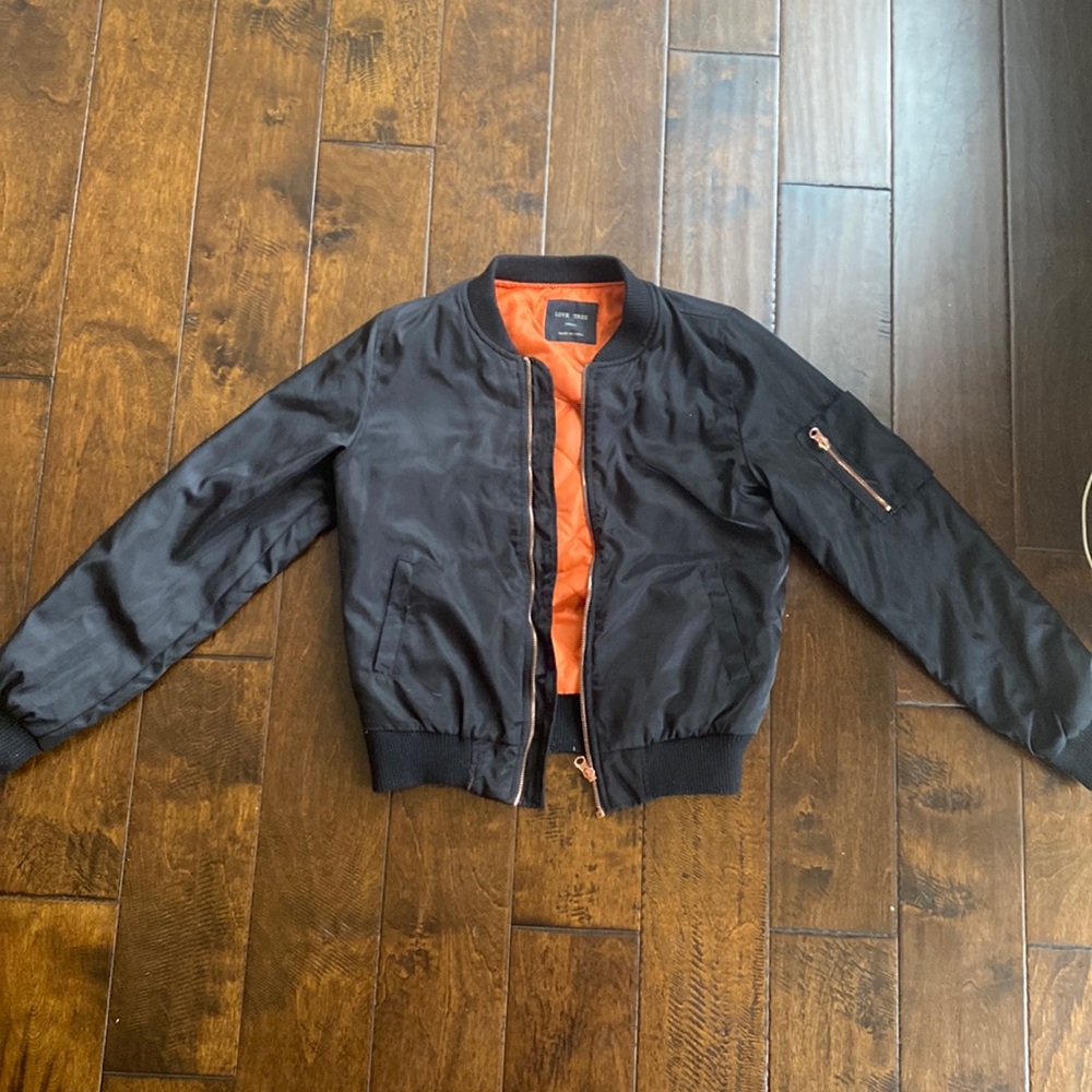 Black bomber jacket with orange in the inside